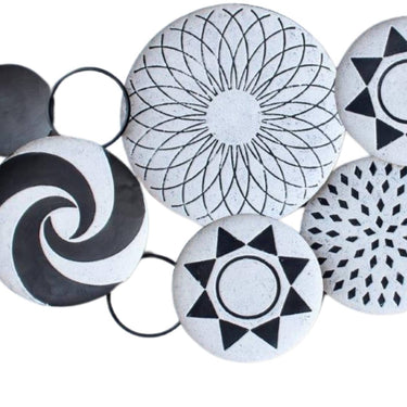 Modern Tonga Metal Wall Decor with black and white circles, inspired by traditional Tonga baskets, enhancing modern interiors.