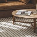 The Molteno Oak Coffee Table styled entrepiece in a modern living room as a solid oak round coffee table on a rug net to a brwon couch