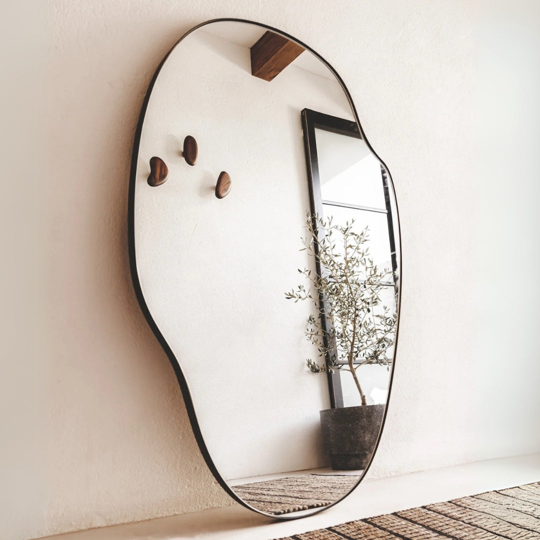 Transform your space with the Molveno wall mirror, designed with a unique organic shape and stainless-steel frame.