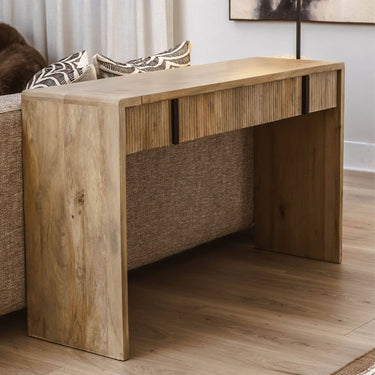 Montuak Wooden console table in a living room setting with a sofa and decorative pillows.
