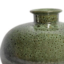 Close-up of the speckled moss green and earthy bronze reactive glaze on a ceramic vessel.