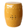 mustard ceramic stool features a high-gloss finish and traditional cut-out details