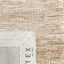 Close-up of the plush polyester texture of Mystery Rug in camel