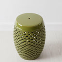 Top view of the dark green ceramic stool showing the smooth surface and openwork style