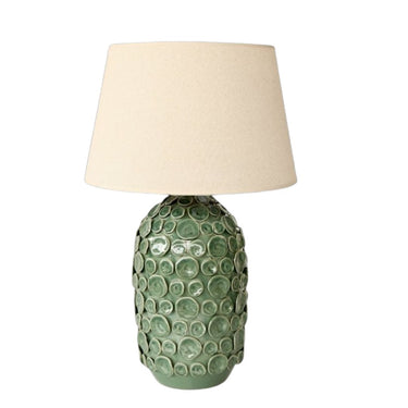 Green textured table lamp with a beige lampshade on a white background