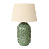 Green textured table lamp with a beige lampshade on a white background