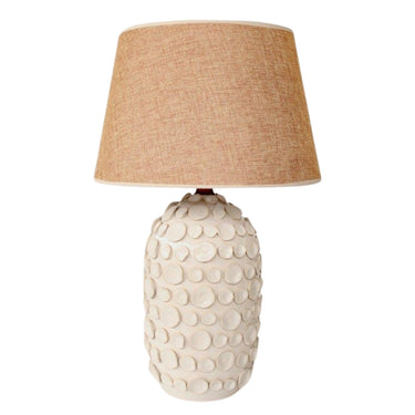 Stylish table lamp with ceramic base and beige shade.