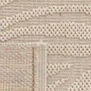 Close-up view of the stain-resistant polypropylene fibre weave on a leaf pattern outdoor rug.