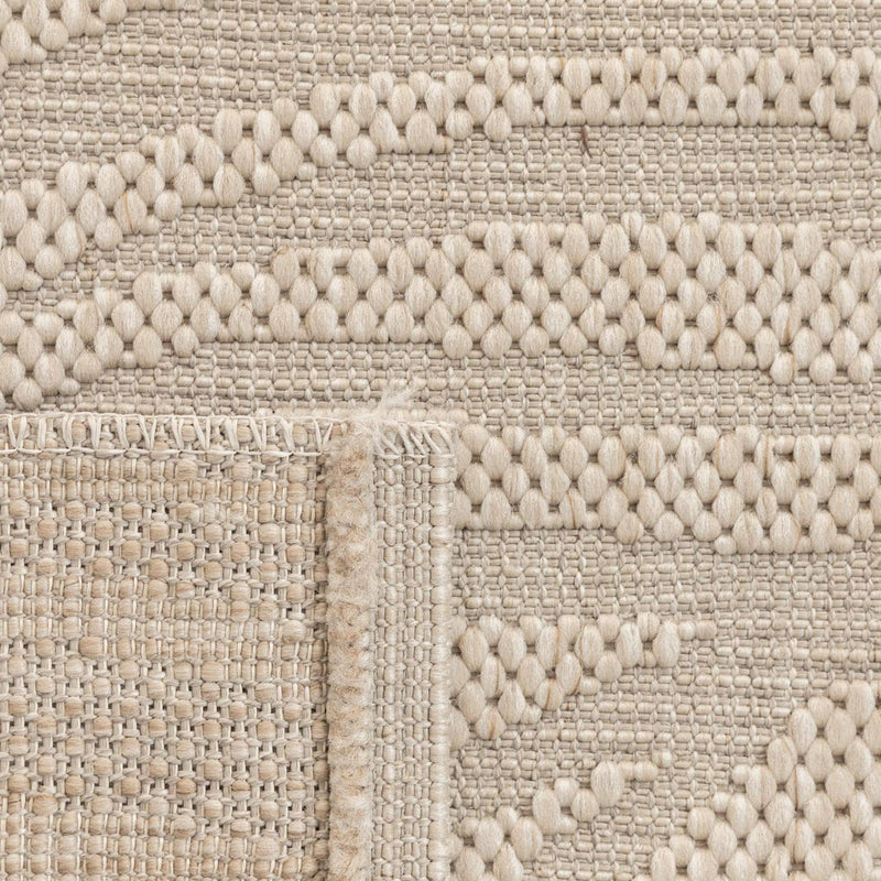 Close-up view of the stain-resistant polypropylene fibre weave on a leaf pattern outdoor rug.