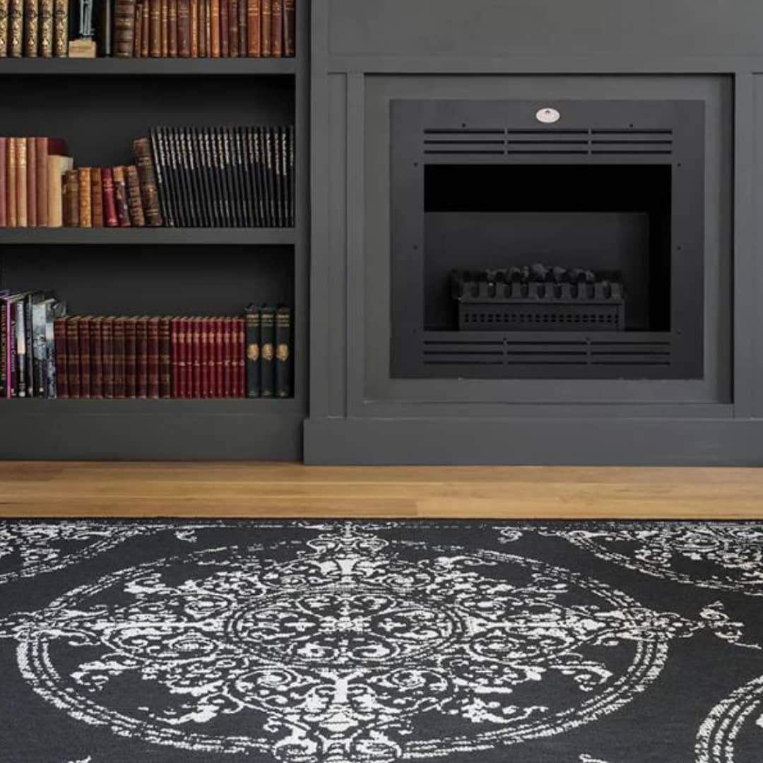 Poletti Black Area Rug in library infront of fire place