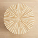 top of a side table with a sunburst design and a mother of pearl finish 