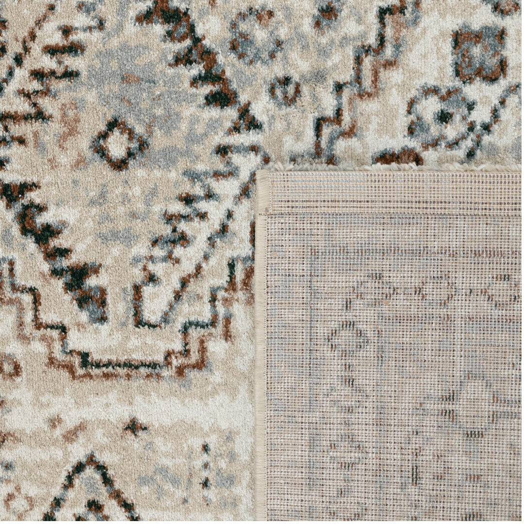Texture detail of the Remnant Rug in Vintage showing the distressed cream and charcoal recycled polyester fibers.