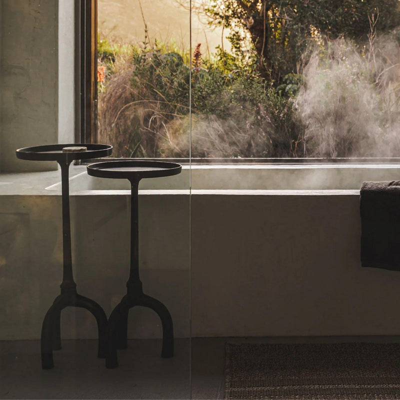 sacred side tables styled in a Modern bathroom with a bathtub