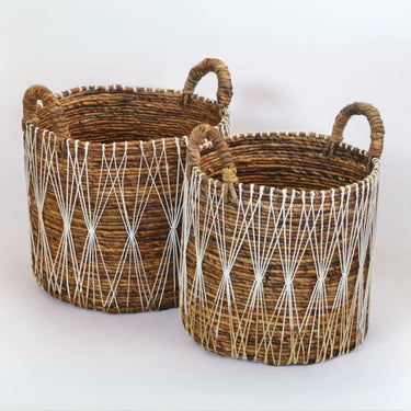 Stylish, natural storage baskets with intricate white details for versatile use.