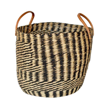 Handwoven seagrass basket with geometric black and natural pattern.