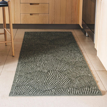 Fully outdoor seychelles runner in green featuring a shell pattern in a kitchen setting.
