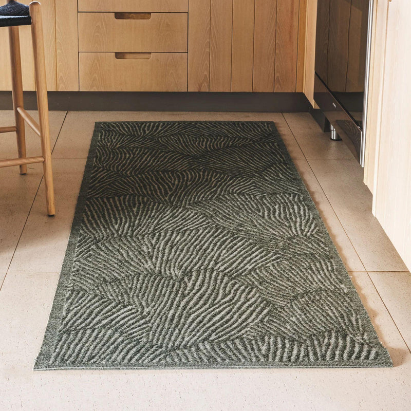Fully outdoor seychelles runner in green featuring a shell pattern in a kitchen setting.
