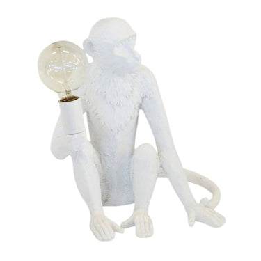 Monkey table lamp in textured resin with seated pose, tail support, and bulb held in one hand