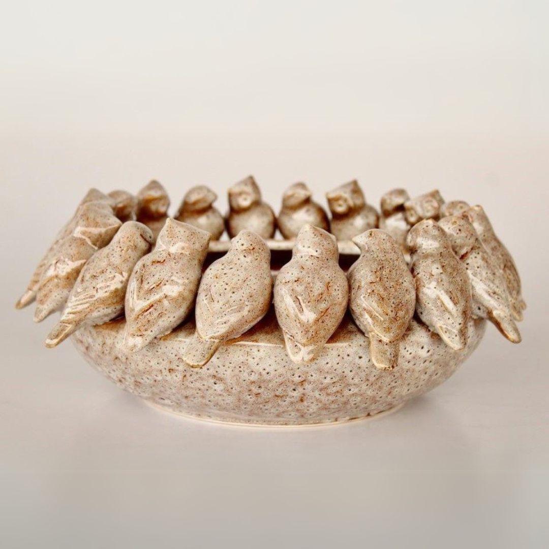 Handcrafted ceramic centerpiece with bird details

