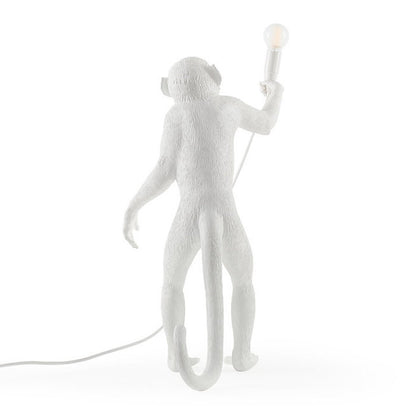 Back view of a standing Monkey table lamp in white