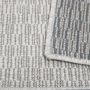 Stain-resistant Stratia Beach Rug in beach color, flat-woven for outdoor and indoor use with natural variation.