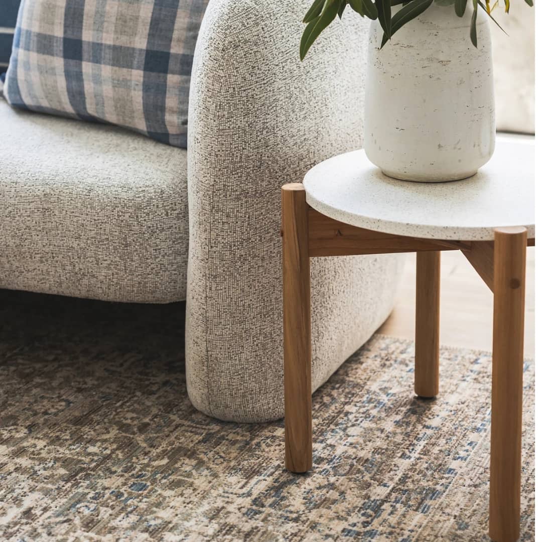 Shop our Side Table Collection at Woodka Interiors, featuring elegant side tables placed next to a couch, perfect for living rooms, bedrooms, and dining spaces.