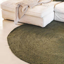 Surround Rug in Jungle styled in a living room with a beige sofa.