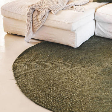 Surround Rug in Jungle styled in a living room with a beige sofa.