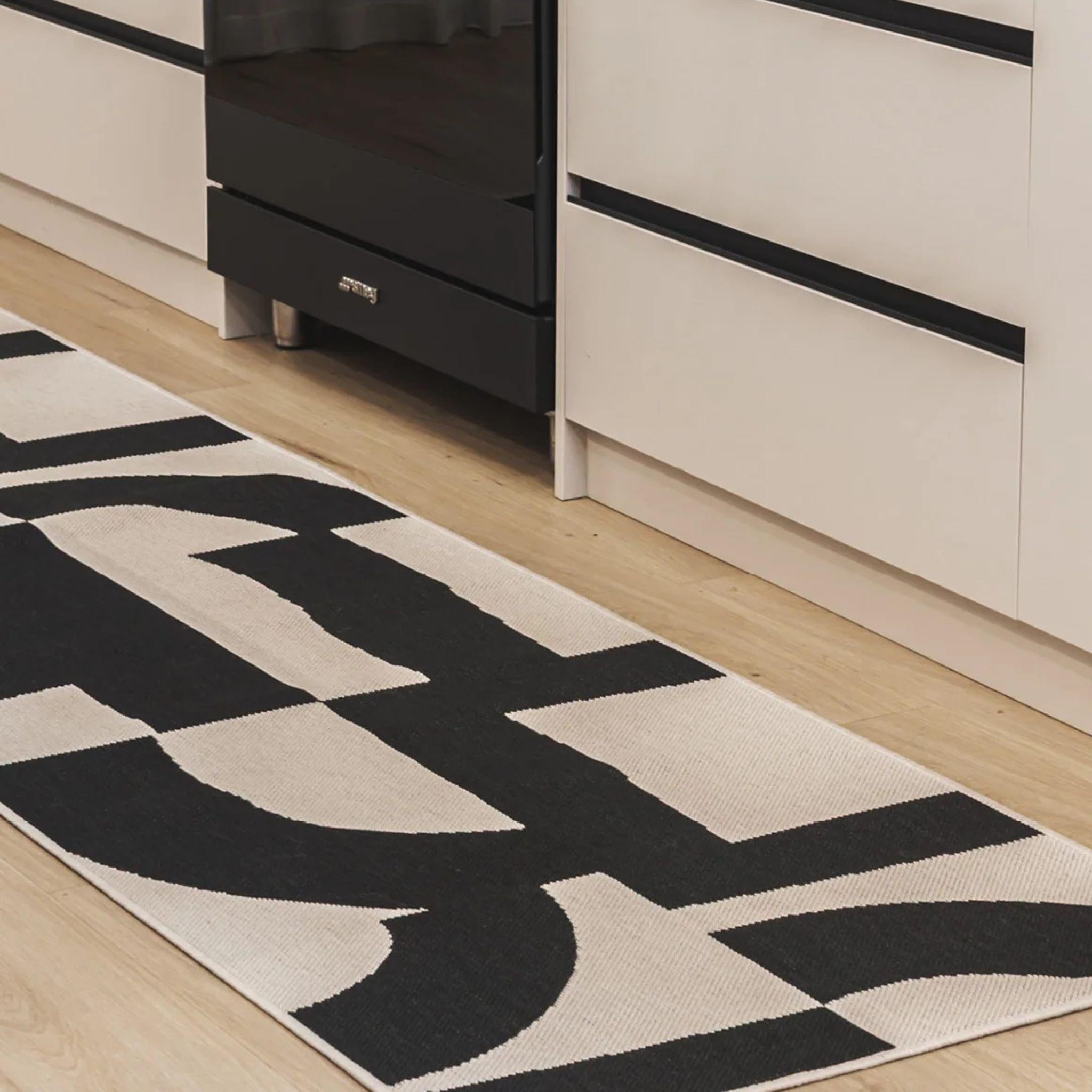 Talon fully outdoor polypropylene runner with a black geometric design in kitchen