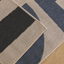 Talon fully outdoor runner close-up of a geometric pattern with black, blue, and beige colors.