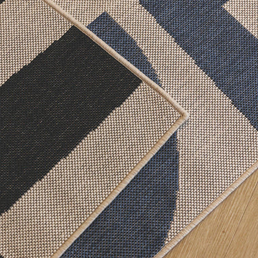 Talon fully outdoor runner close-up of a geometric pattern with black, blue, and beige colors.