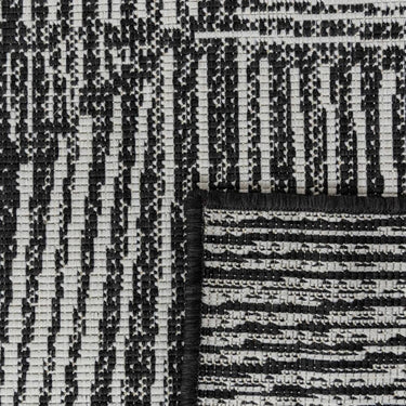 Close-up of polypropylene weave on a Tangram reversible geometric outdoor rug in inkwell option