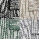 Tangram outdoor rug showing four colours and reversible geometric pattern.