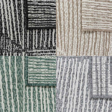 Tangram outdoor rug showing four colours and reversible geometric pattern.