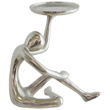 Abstract figure pillar candle holder supporting a round candle plate