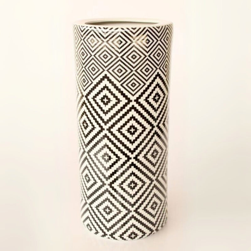 Geometric-patterned ceramic umbrella stand in black and white for versatile home decor.