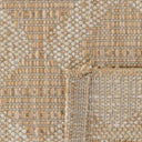 Close-up of a polypropylene patio rug with a beach geometric trellis pattern from the Vava'u Outdoor Rug collection.