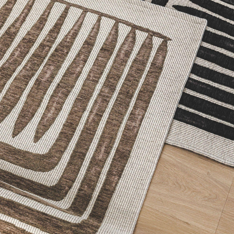 Vertigo Rug in Hazel with geometric and botanical design, styled in a soft-toned bedroom floor