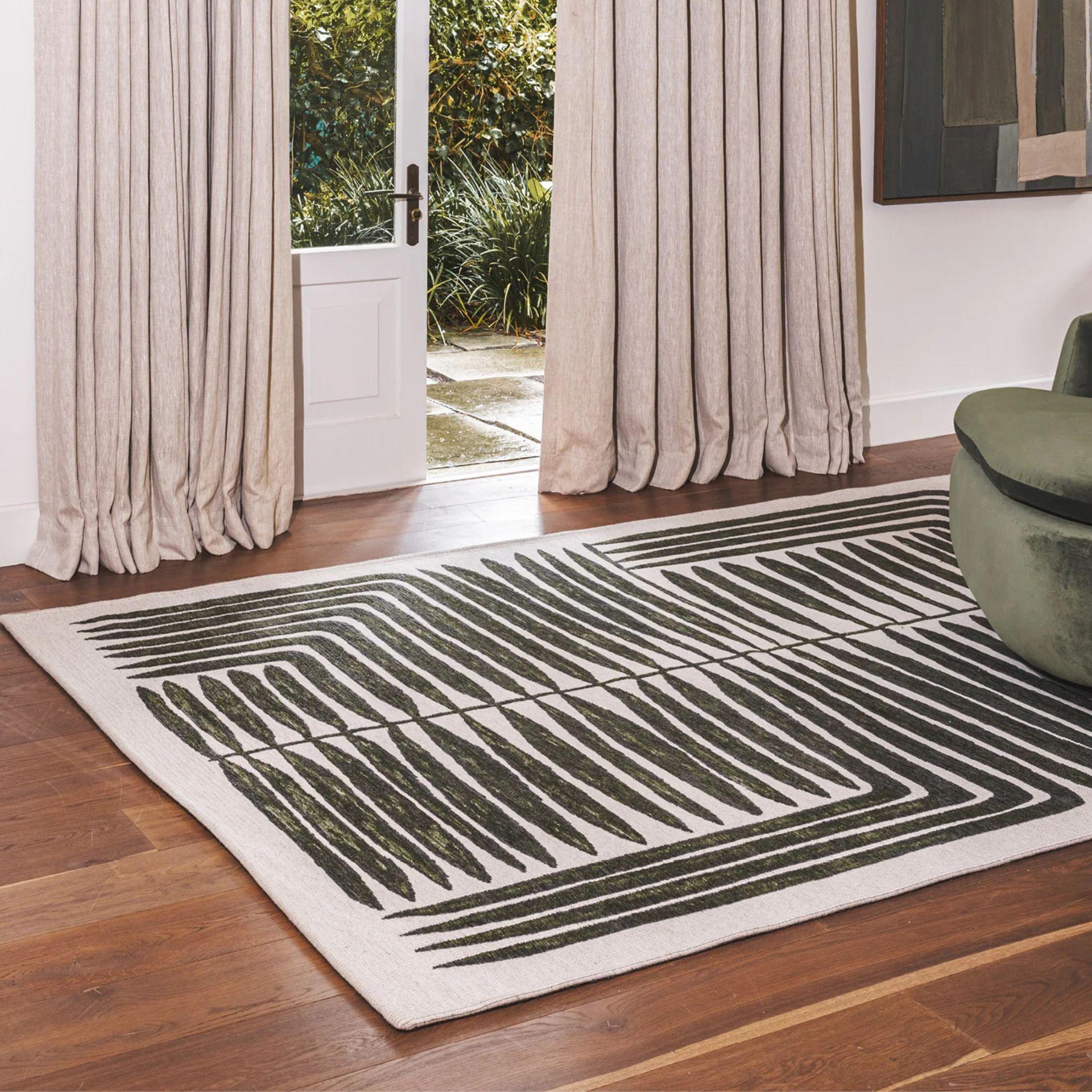 Vertigo Rug in Jungle with green and natural tones in a botanical-geometric pattern, styled in a serene living Room