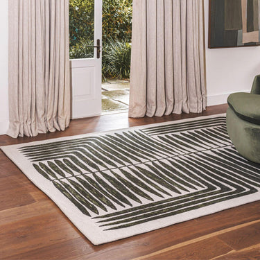 Vertigo Rug in Jungle with green and natural tones in a botanical-geometric pattern, styled in a serene living Room