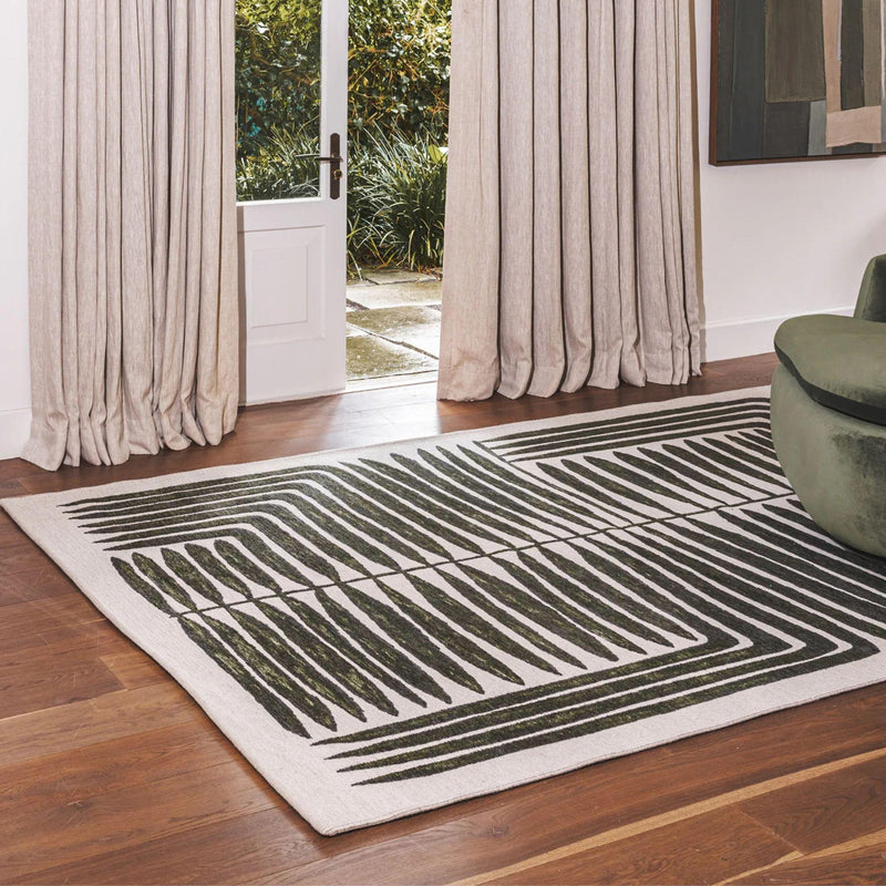 Vertigo Rug in Jungle with green and natural tones in a botanical-geometric pattern, styled in a serene living Room