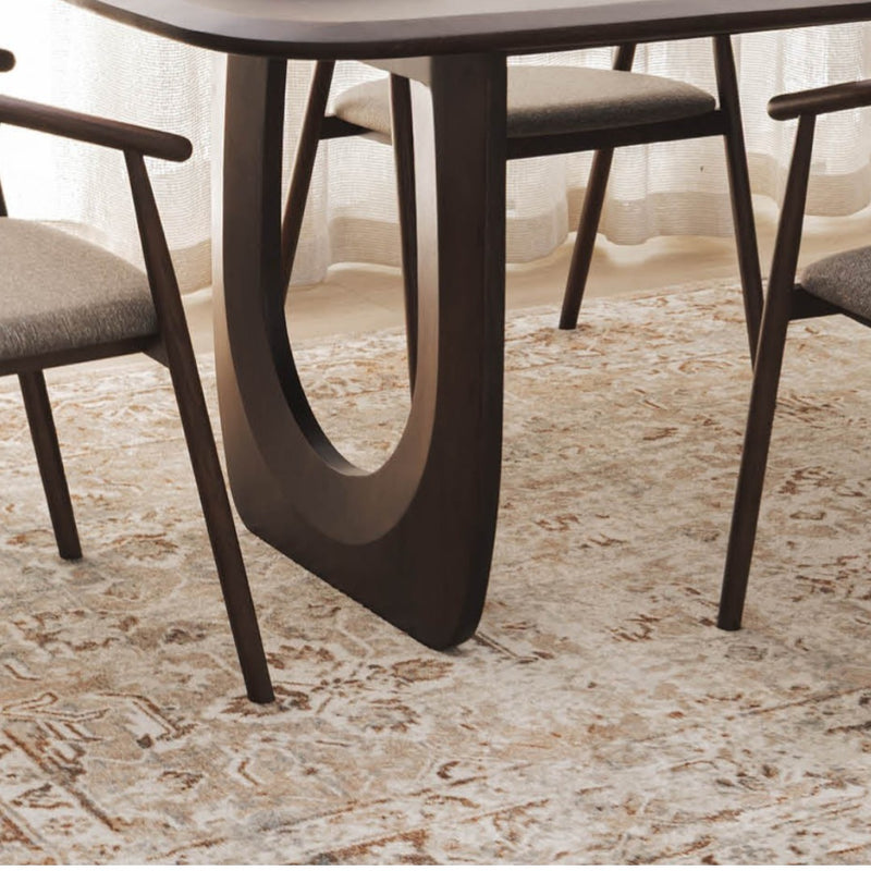 Archive Rug in Vintage styled under a modern dining table with upholstered chairs at Woodka Interiors