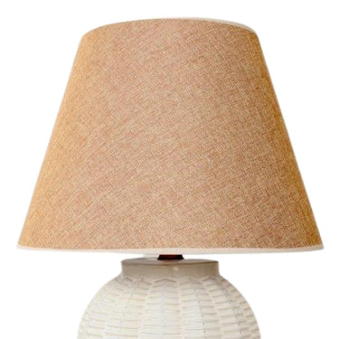 Elegant bedside lamp with ceramic basket-inspired design.