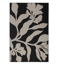 The Wildvine Rug in ebony, a durable polypropylene flatweave rug with a minimalist floral design.
