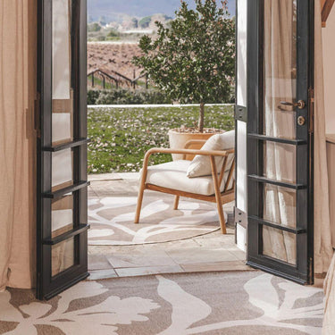 Styled outdoor seating area featuring the Wildvine Rug as an outdoor rug centerpiece