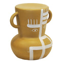 Abstract face ceramic stool in tan with white illustration