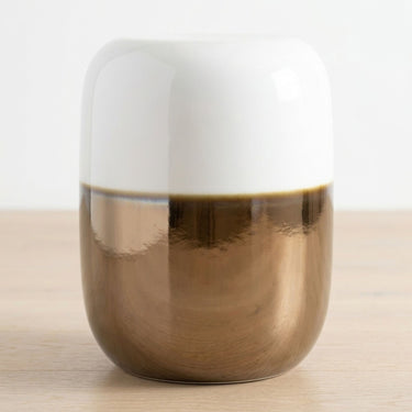 ceramic stool with white and bronze two-tone finish.