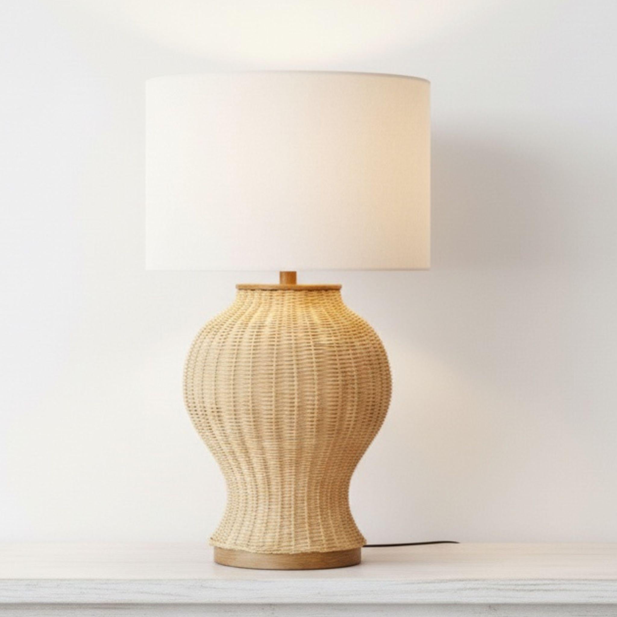  rattan large lamp with a woven urn-shaped base and drum shade styled on a minimalist wooden desk for organic home decor