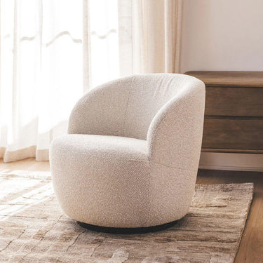 upholstered swivel chair living room on a warm toned rug infron of a dark wood console table
