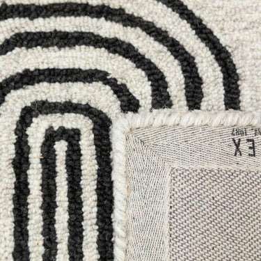 Close-up of arcade rug in Domino showing hand-tufted wool texture and contrasting shapes